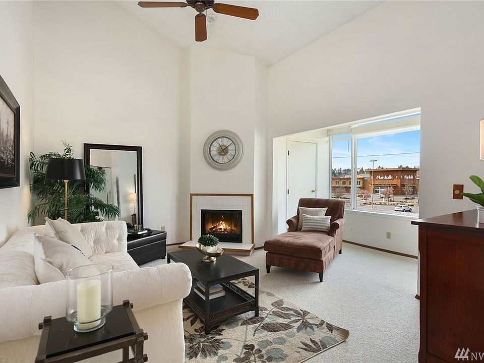 You'll appreciate the light and airy feeling of this family room with soaring ceilings, cozy fireplace, and ceiling fan. 