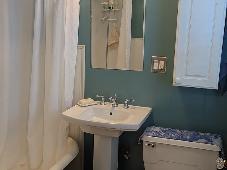 Bathroom with original clawfoot tub.