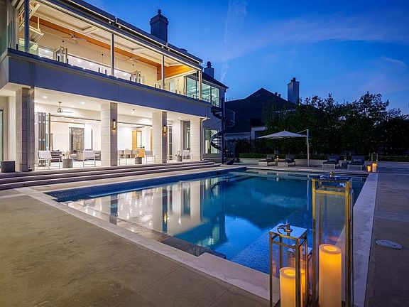 With the folding door system, the downstairs extends to an amazing outdoor space including a sprawling salt water pool surrounded with luxury lime stone decking and views of the lake.