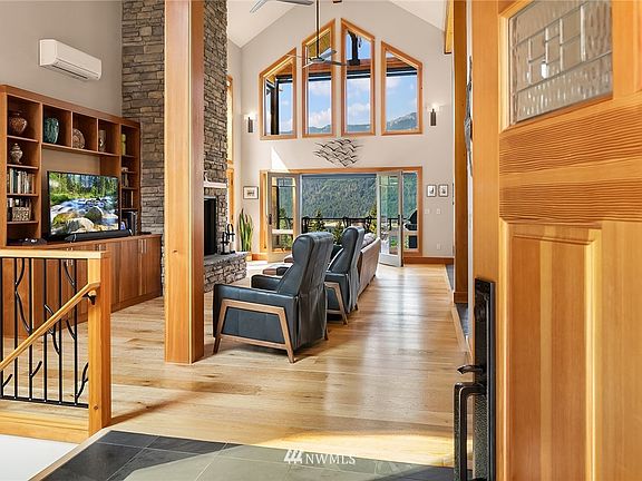 Soaring ceilings and a wall of windows beckon you to come in and soak up the sun and the views.