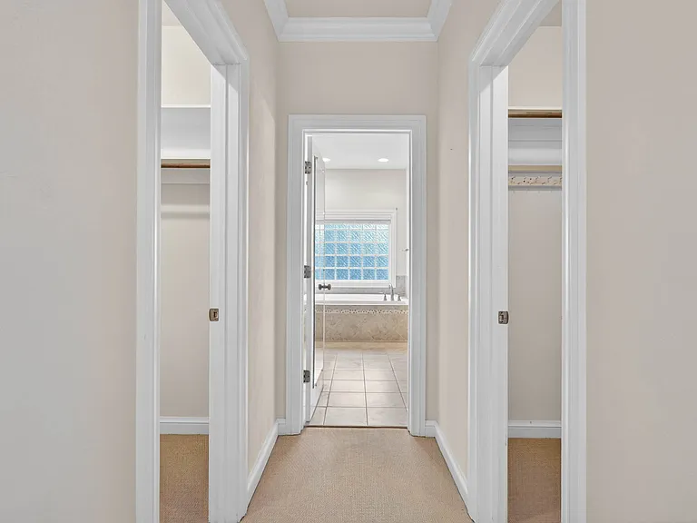 1st Floor Primary Suite, into bath and dual walk-in closets
