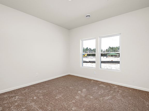 The bedrooms in this home have carpet.