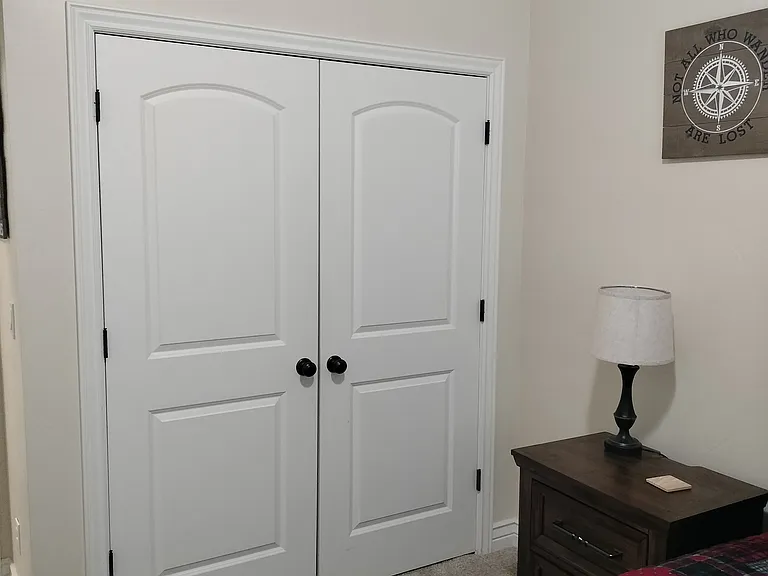 Two inviting guest bedrooms feature Smart TVs and convenient touch lighting, offering comfort and modern amenities for a relaxing stay. Perfect for unwinding and enjoying a restful night.