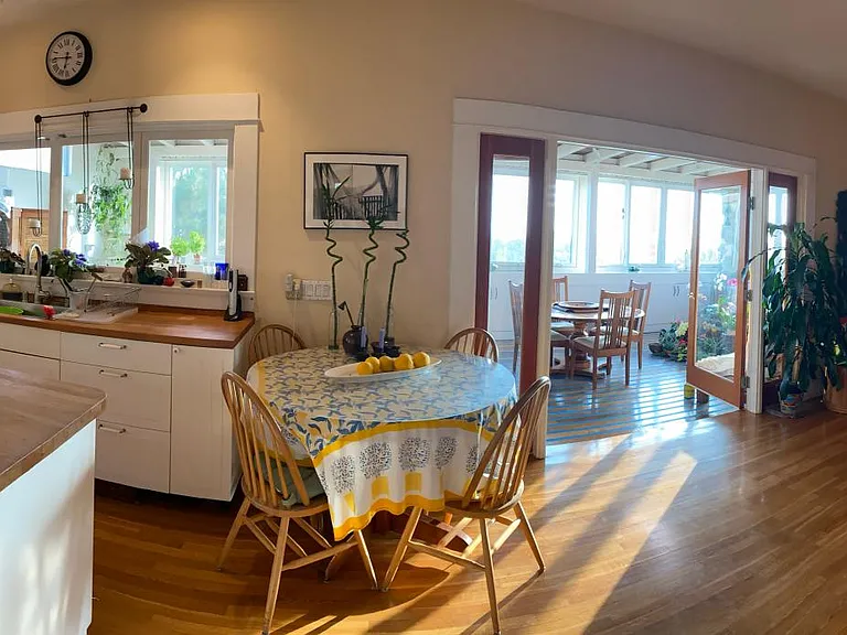 Kitchen, Great Room with fireplace, Media room/library looking onto west-facing porch.