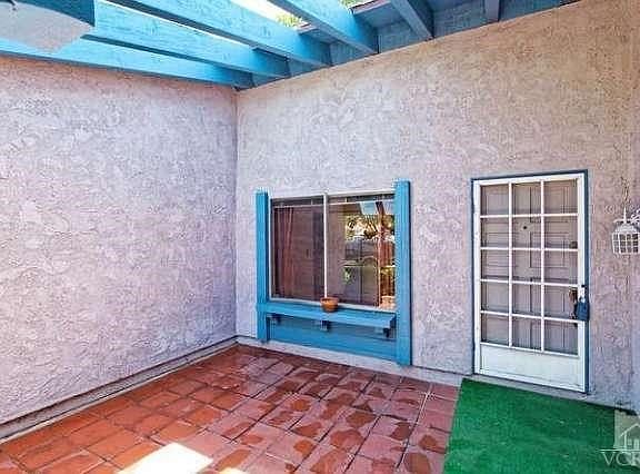 Front ~~~ Grassy yard ~~~ Concrete Driveway and walkways ~~~ Brick accents ~~~ Raised panel entry door w/screen door ~~~ Composition tile roof ~~~ 2-car garage w/roll-up sectional door and side door to front entry area