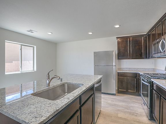 Chef-ready kitchen with stainless appliances and granite countertops.