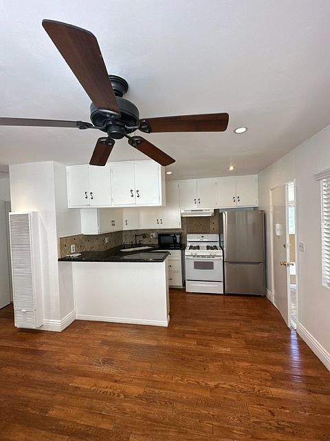 Another view of the living room, ceiling, fan, and kitchen. This whole area is wonderful to socialize in while dinner is being made, and a glass of wine is enjoyed with the conversation!