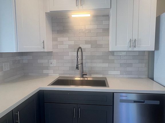 Newly renovated gourmet kitchen featuring quartz countertops, stainless steel appliances, a large pantry, abundant storage, and the convenience of an in-unit washer and dryer.