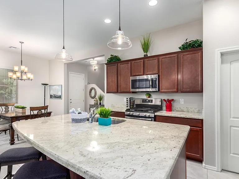 Modern stainless steal GE appliances with a walk in pantry.