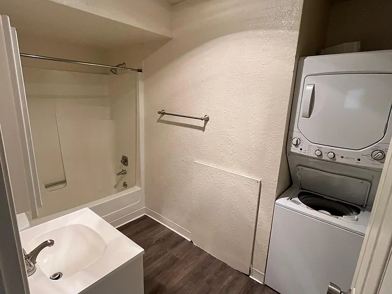 Hall bathroom with stack washer/dryer