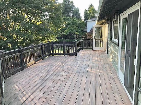 Back of house / deck from kitchen & living room down to backyard