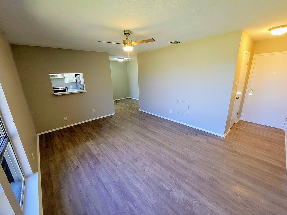 Living room; entrance and front closet on right; kitchen and dining area back left