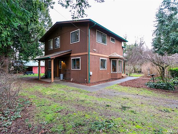 Front door leads to entry into upstairs, small suite on right and kitchen, dining and den on left. Side door leads through utility room into den, dining and kitchen. All these double pane windows allow for lots of light in the home.  