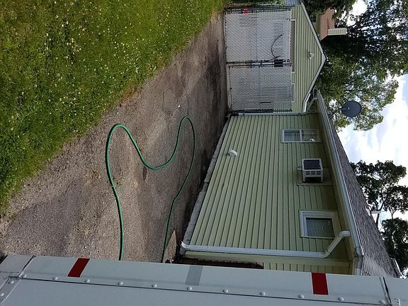 Driveway holds three vehicles garage building in the back for story