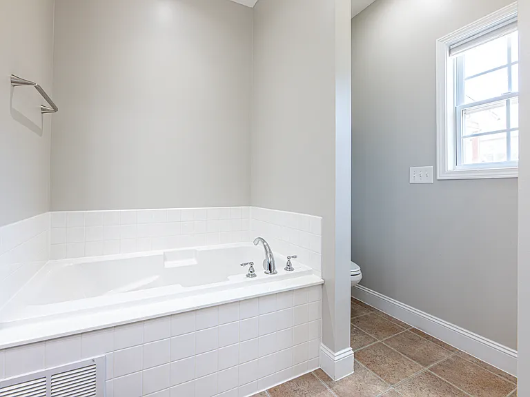 Master bathroom features double vanity sink, jetted soaking tub and walk in shower