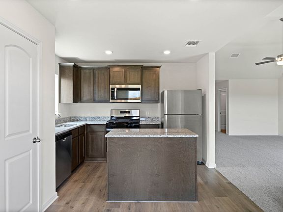 The kitchen has gorgeous wood cabinetry.