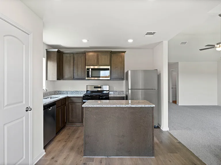 The kitchen has gorgeous wood cabinetry.
