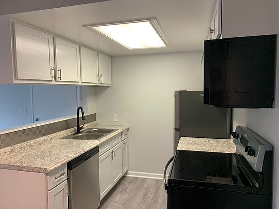Kitchen with Electric Stove, Microwave, Refrigerator, and Dishwasher