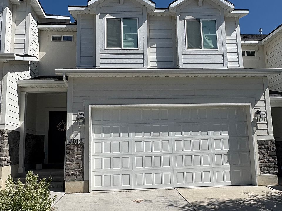 Front load townhome with 2 car garage and 2 parking spaces in driveway