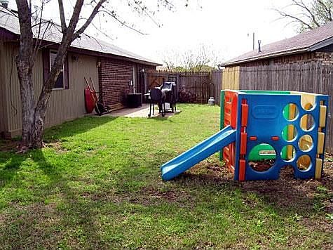 Side yard has patio great for grilling