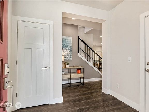 Front Entrance through the red main door. Walk-in coat closet on the left and 2-car garage door on the right.