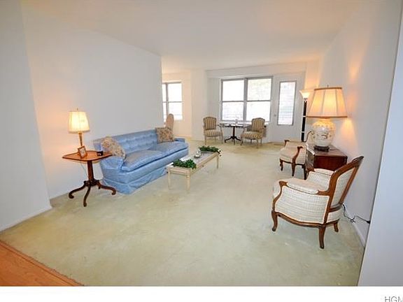 Large sunny living room opens to the "L" shaped dining room and has a door leading to the private Balcony .  The living room also opens to the entry foyer that can be used as a home office area or dining area.  The living room has covered parquet floors a