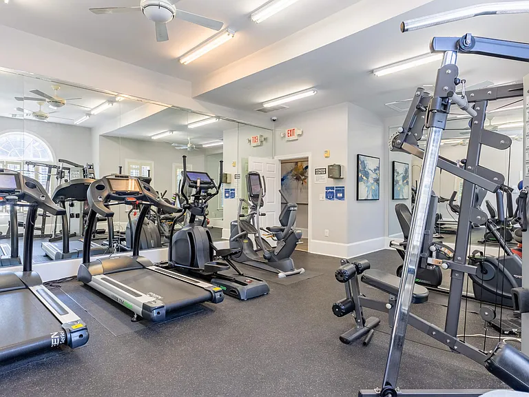 Large fitness center with ample lighting at Heron Lake