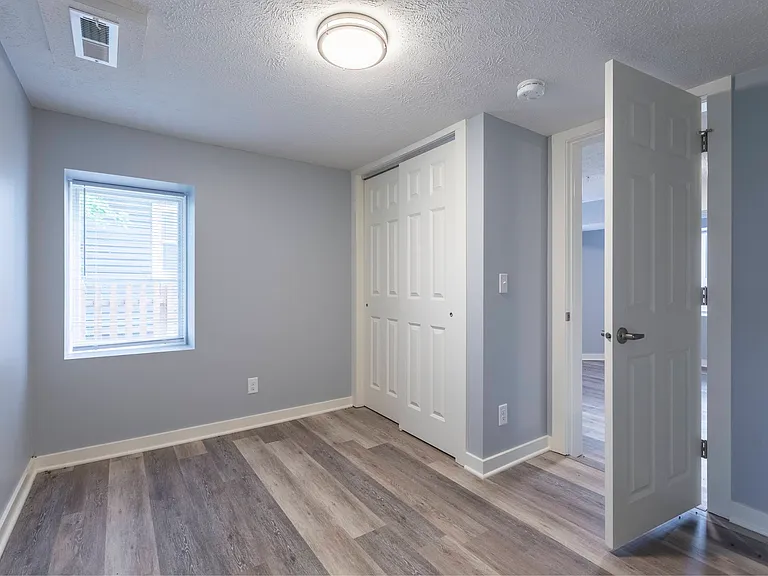 Bedroom with a large closet at Park Avenue Apartments.