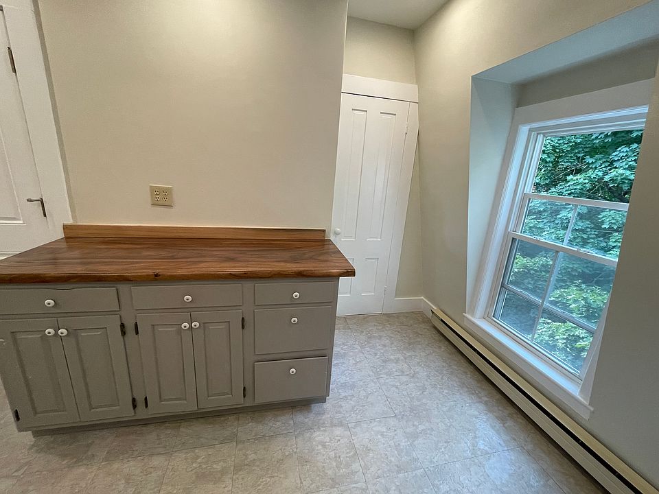Kitchen buffet and pantry with rear entrance on the left.