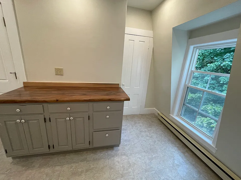 Kitchen buffet and pantry with rear entrance on the left.