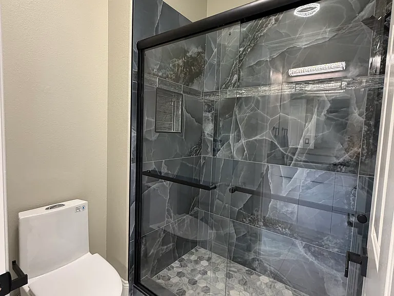 Shared Jack-and-Jill bathroom with private shower and toilet