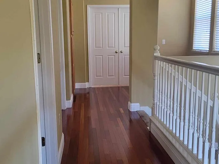 View from 4th bedroom/laundry room towards 3rd bathroom (first left), 3rd bedroom (second left), and master bedroom (end of hall)
