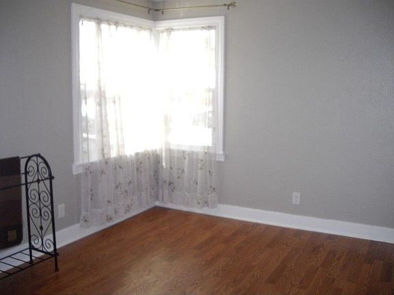 Bedroom with laminate flooring and designer paint.