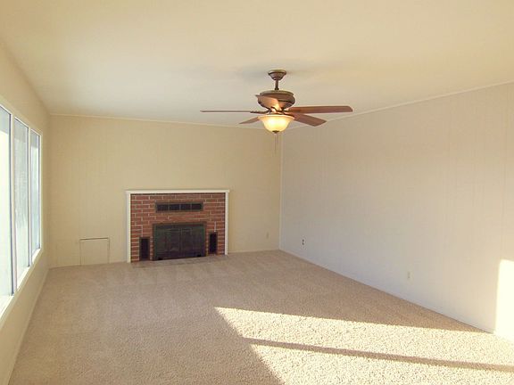 Living room has new paint, carpet and light fixtures