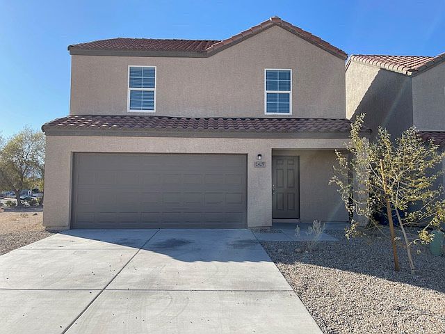 Front of home with 2-car garage and paved driveway