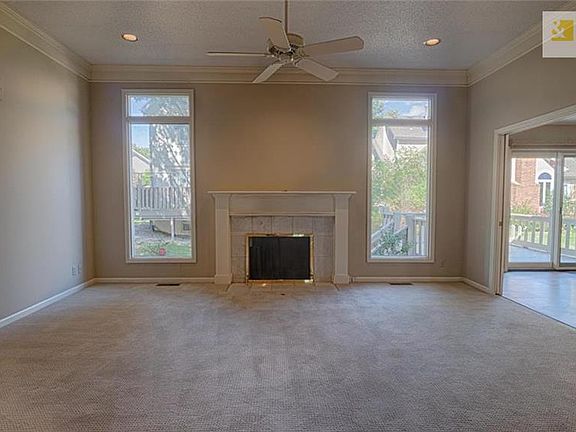 Large living/dining room with floor to ceiling windows and lots of light.
