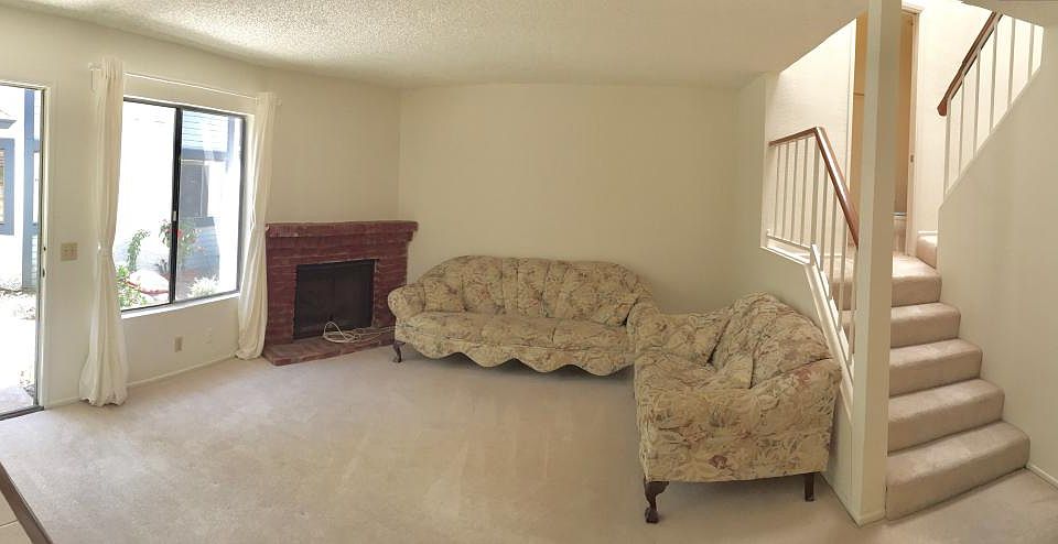 Living room flush with natural light and cozy fireplace