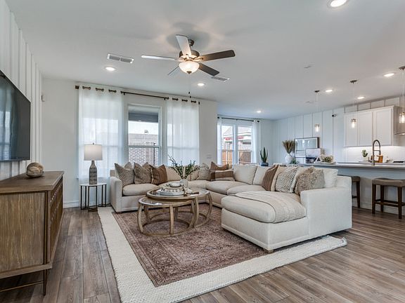 Spacious gathering room with view of kitchen Model representation