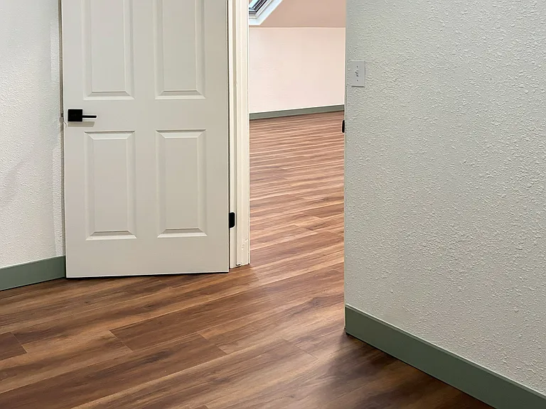 Inside the bonus room looking out to living area.