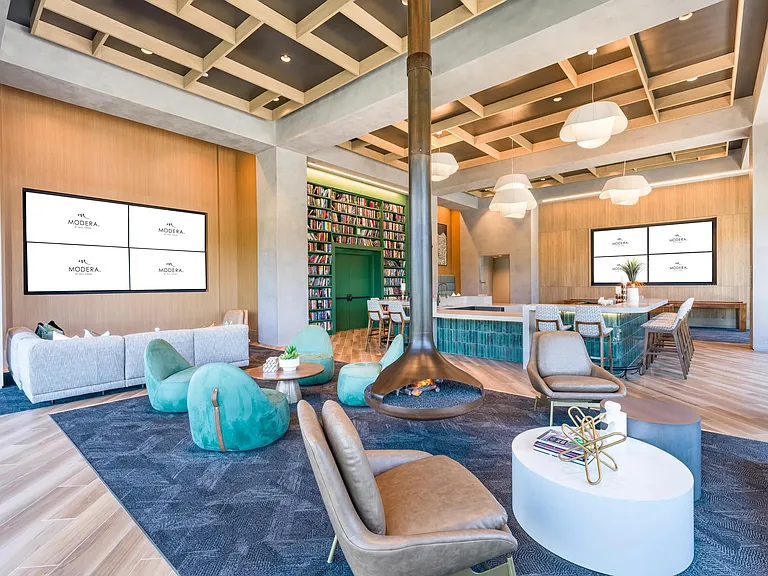 This inviting resident lounge is your everyday escape, featuring cozy fireside seating, oversized screens, and ample space to relax or connect.