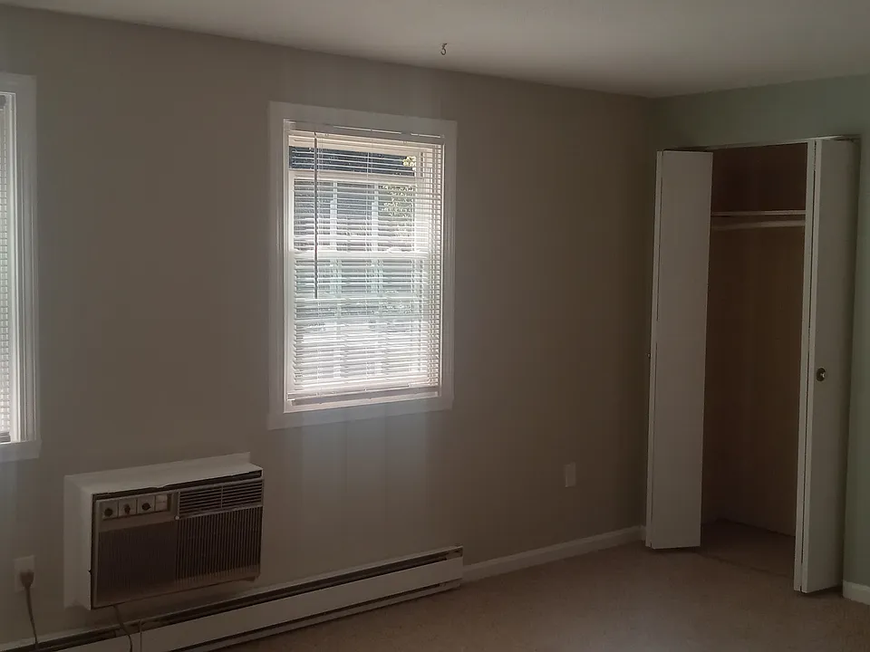 Spacious master bedroom with ample closet space. The master bedroom includes a sleeved air conditioner.