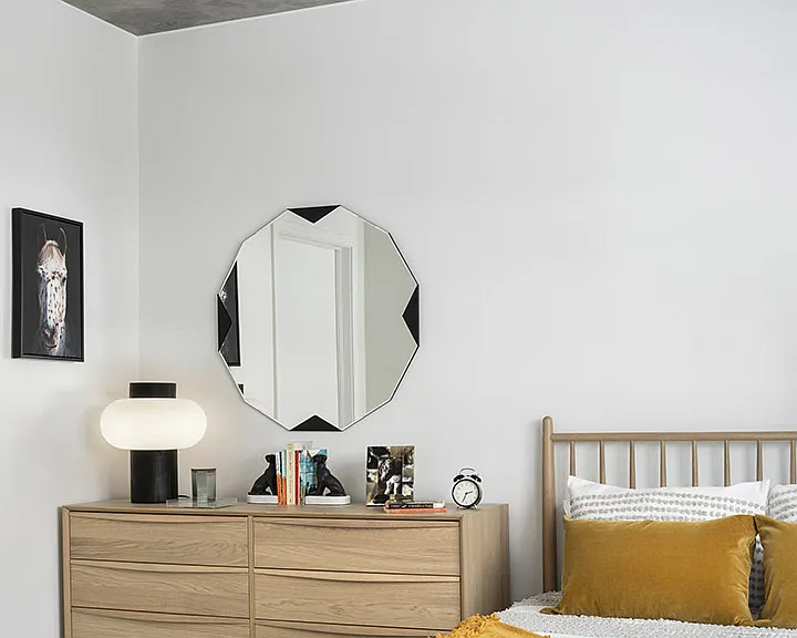 Spacious apartment bedroom with wood floors.