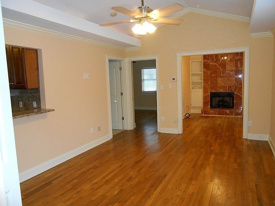 This is a wonderful light living room with hardwood floors and a vaulted ceiling.