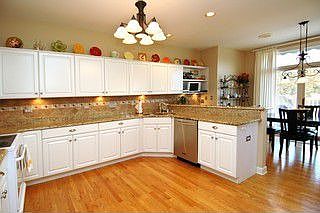 Granite, tumbled marble backsplash, wood floors, freshly painted