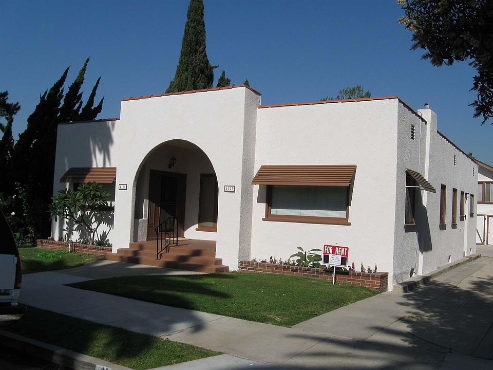 1920's Spanish Style view of triplex, unit for rent is in driveway above the garage.
