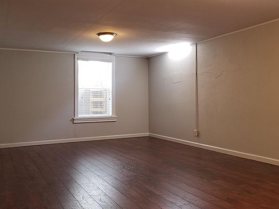 Finished family room space in basement with easement window 