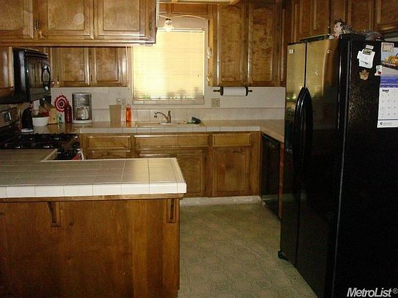 Over all view of kitchen. Kitchen has 2 installed microwaves. one is noted above the stove on the left side of this picture.