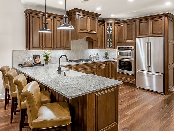 Spacious Kitchen With Granite Countertops and Stainless Steel Appliances