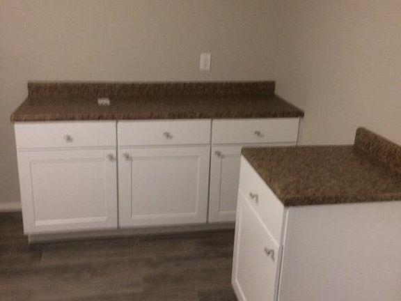 over sized laundry room with cabinets