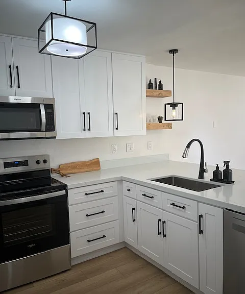 Brand new modern kitchen with high end appliances, cabinets, fixtures and quartz countertops